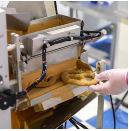 A Tail Bangers baker hand-finishing a gourmet dog treat